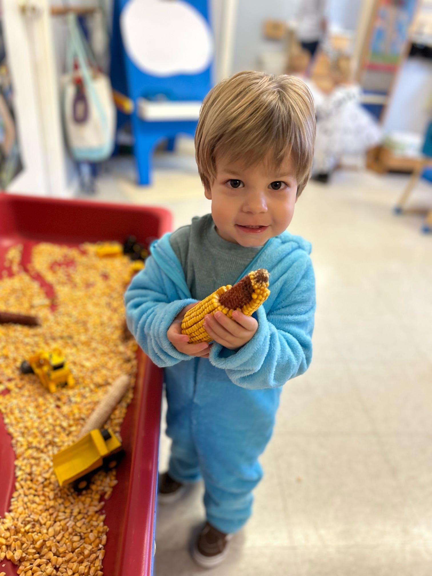 A young boy is holding a piece of corn on the cob.