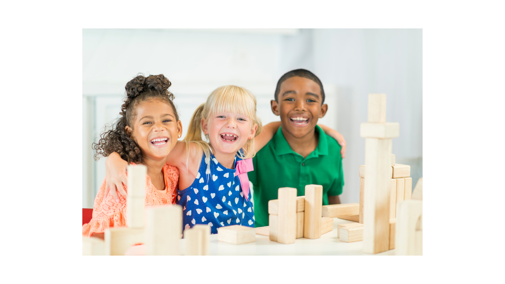 Three children are sitting at a table playing with wooden blocks.