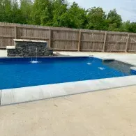 inground pool with waterfall