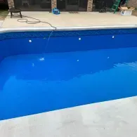 inground pool with bright blue liner