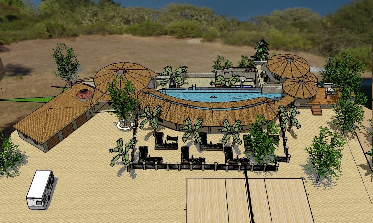 Aerial view of a desert resort with pools, thatched huts, trees, and a white van parked nearby.
