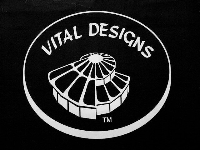 Vital Designs logo in white on black, featuring a stylized spiral building shape.