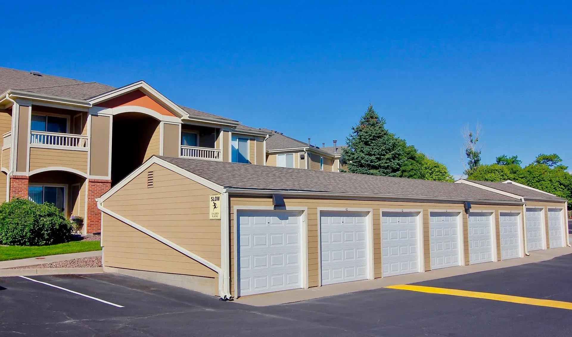 Thumbnail 41 of 51 - A row of garages in front of apartment buildings.