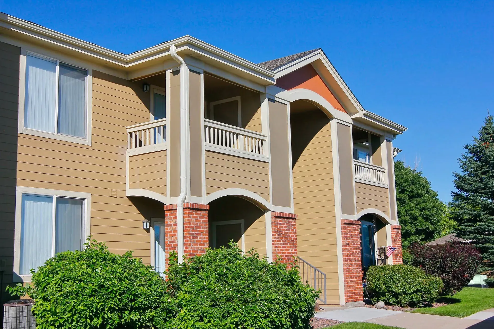 Thumbnail 45 of 51 - A two-story apartment building with a balcony on the second floor.