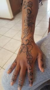 A close up of a person 's hand with a tattoo on it