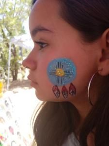 A woman with a flower painted on her face