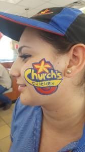 A woman with church 's chicken painted on her face