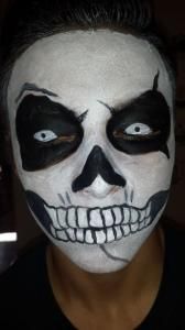 A person with their face painted like a skull.