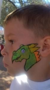 A young boy has a dragon painted on his face