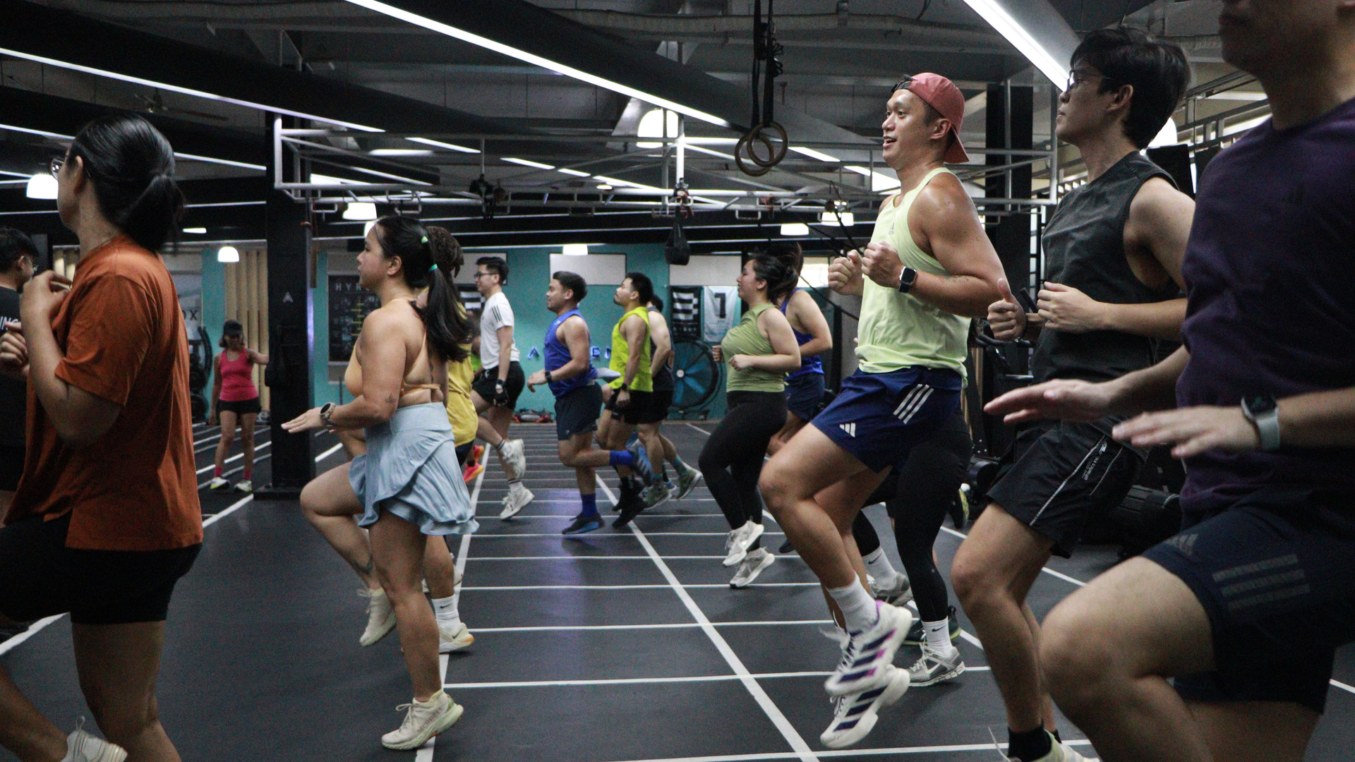 People exercising in a mirrored dance studio during a group fitness class