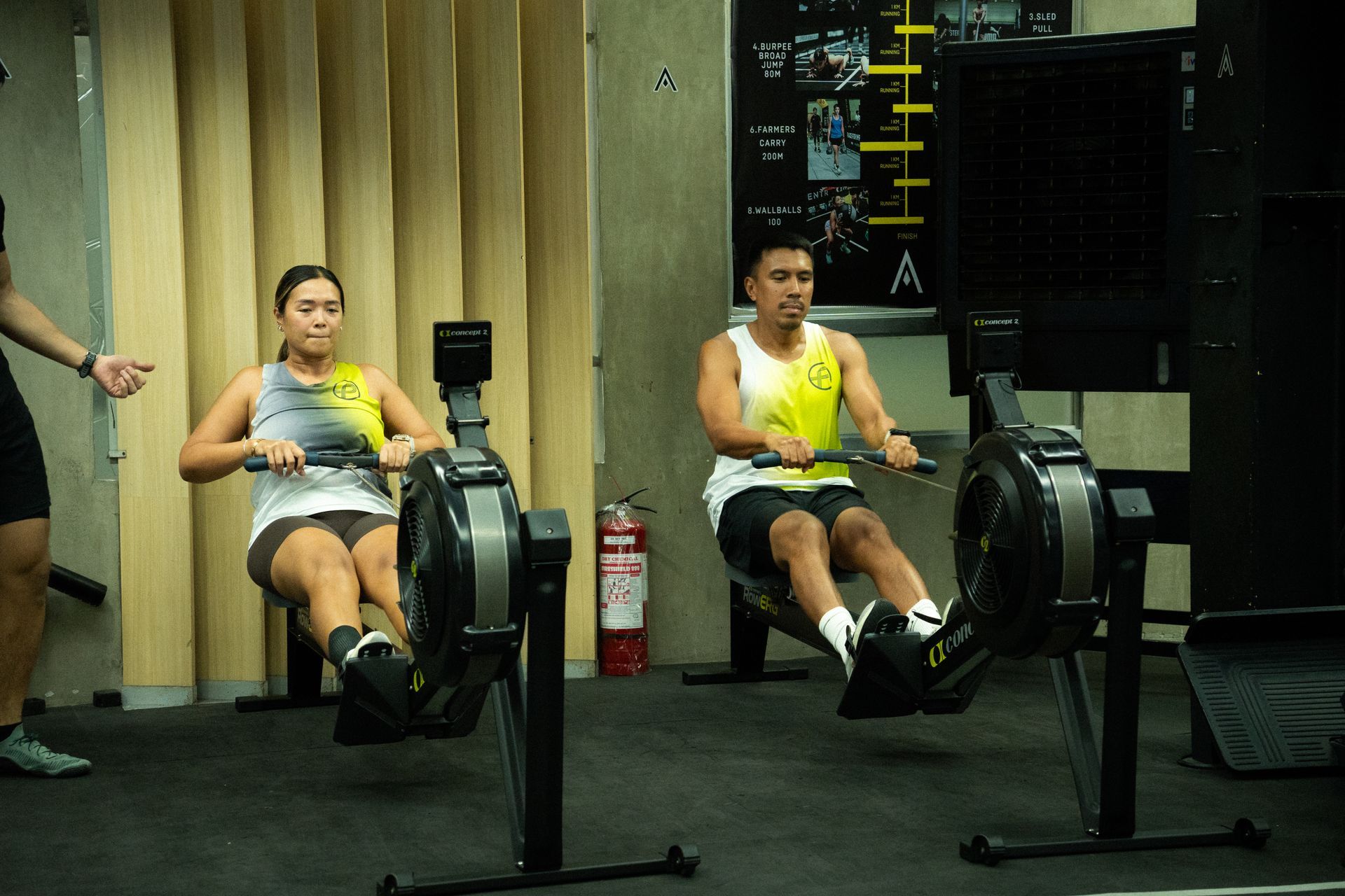 Two athletes doing row ergs at Awaken Fitness Center