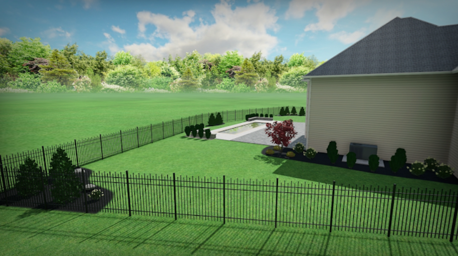 Backyard with a black fence, pool, and house on a sunny day. Green grass, trees, and landscaping.