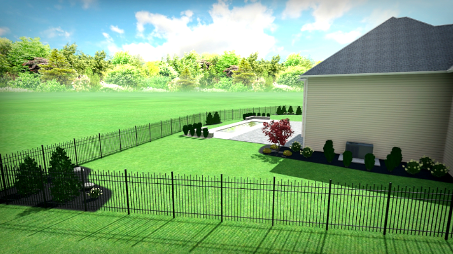 Backyard view of house with pool, black fence, green grass, trees and landscaping.