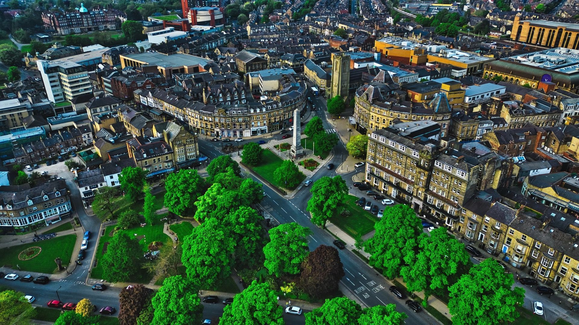 Aerial view of Halifax, England with a park in the foreground and buildings in the background.