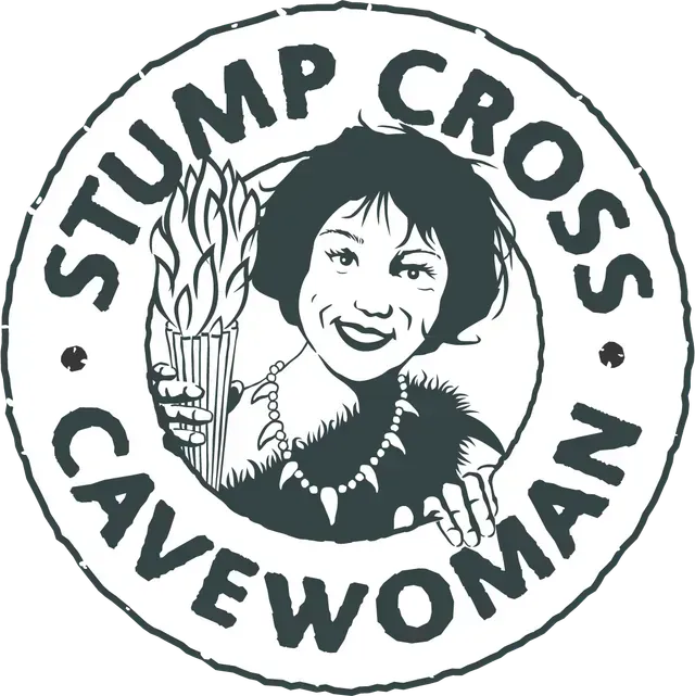 Stump Cross Caverns logo: Cavewoman holding torch, wearing necklace, encircled by text.