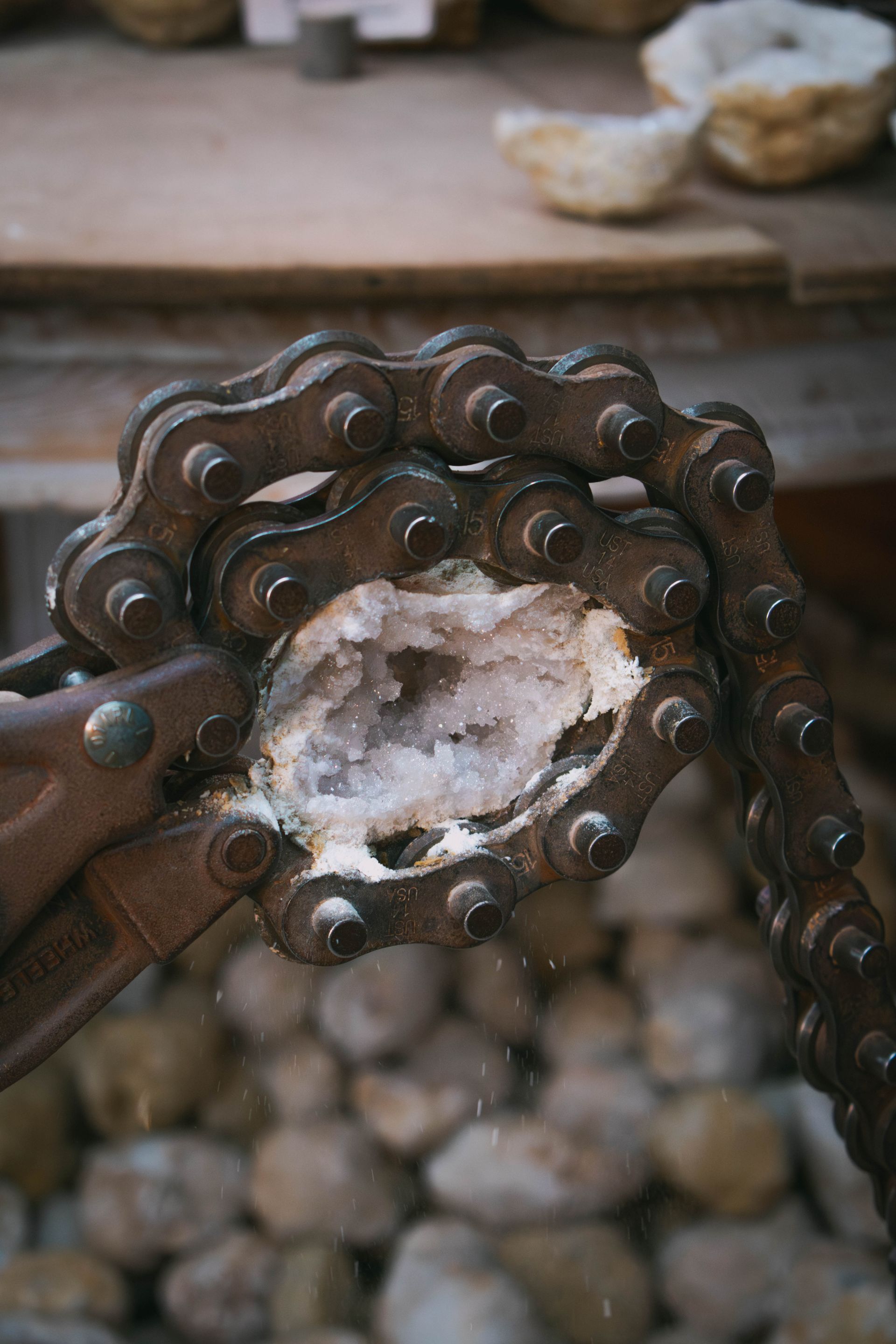 Close-up of a geode with a hollow center filled with sparkling white quartz crystals.