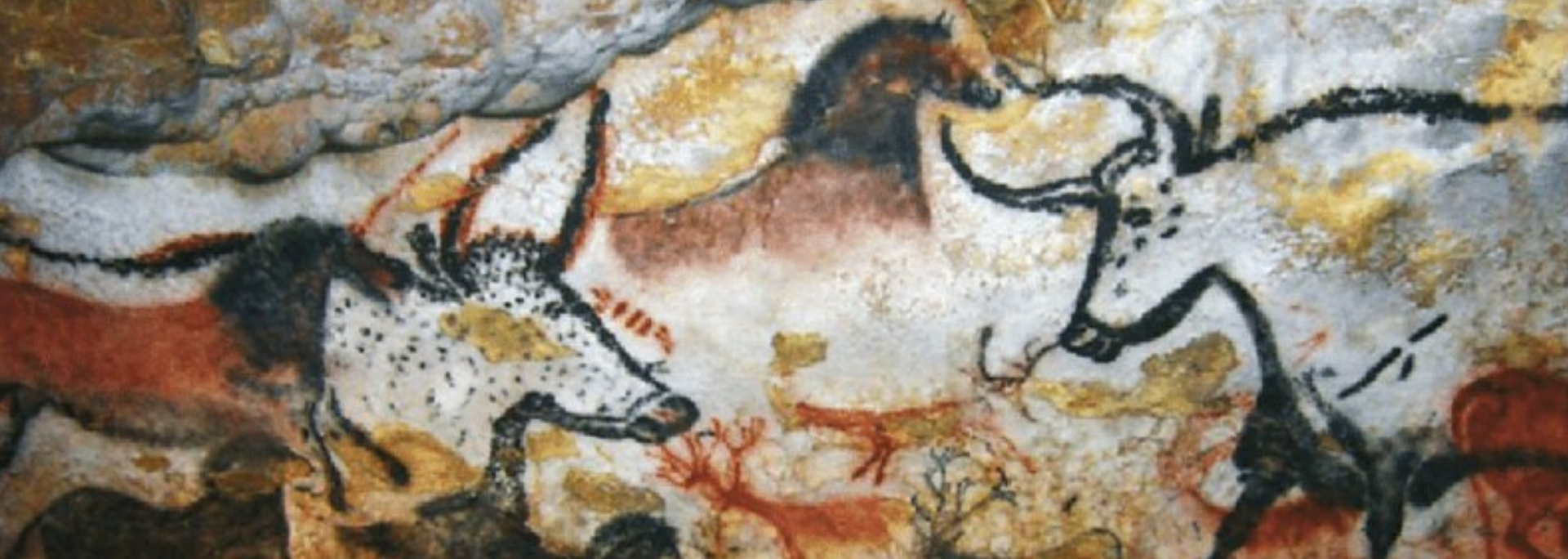 Cave painting of animals: horses, deer. Red, brown, and black figures on a beige rock surface.