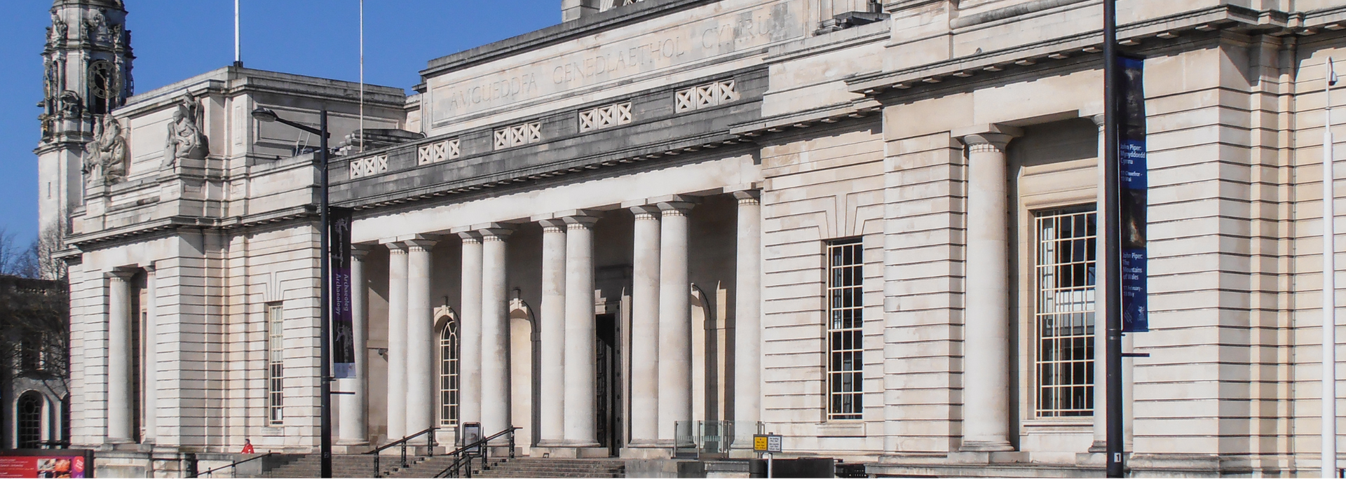 Exterior of a light-colored building with columns, likely a government or public structure.