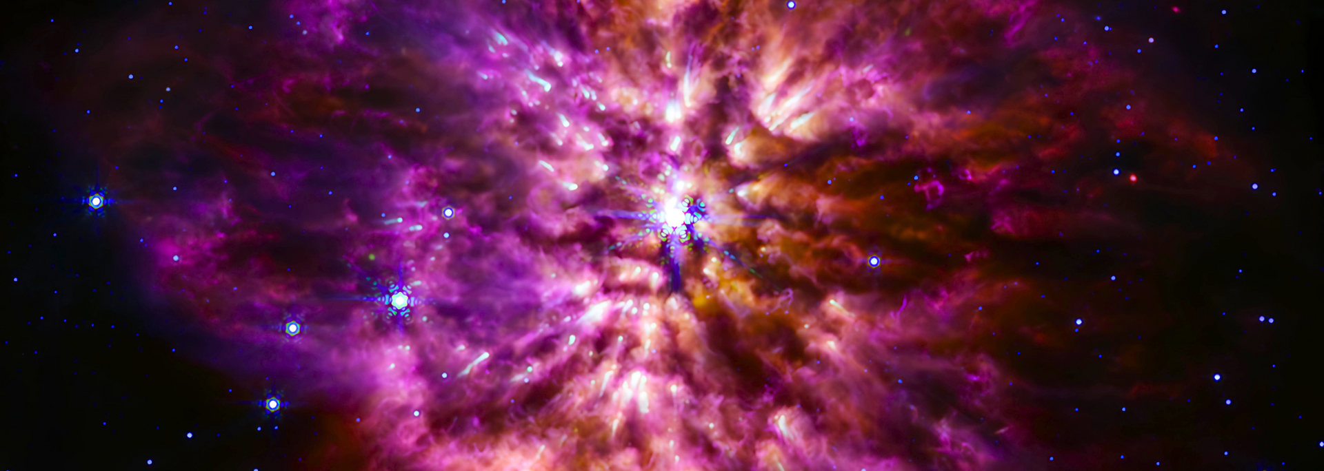 Nebula with swirling purples, pinks, and oranges, with a bright white center, and scattered stars.