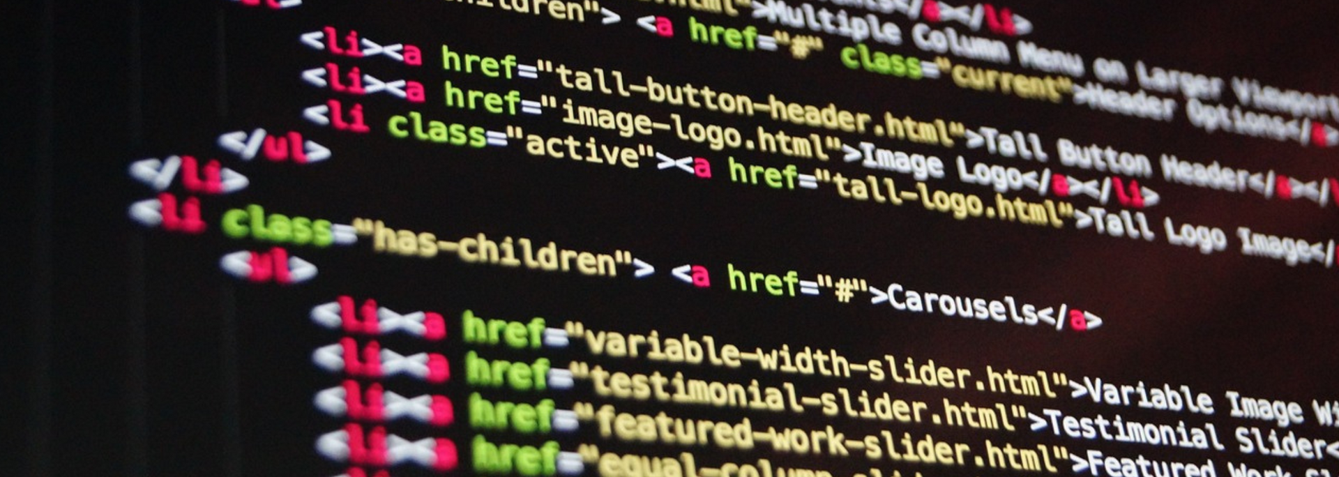 Code on a dark screen, highlighting HTML elements with various colored tags.