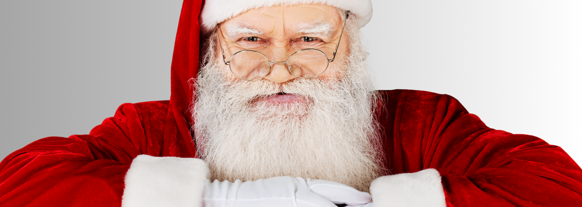 Santa Claus, wearing a red coat and hat, looking at the viewer.