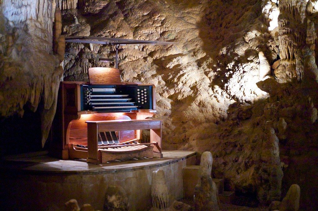 Cave organ: Wooden instrument built into a cave. Stalactites and stalagmites surround the organ.