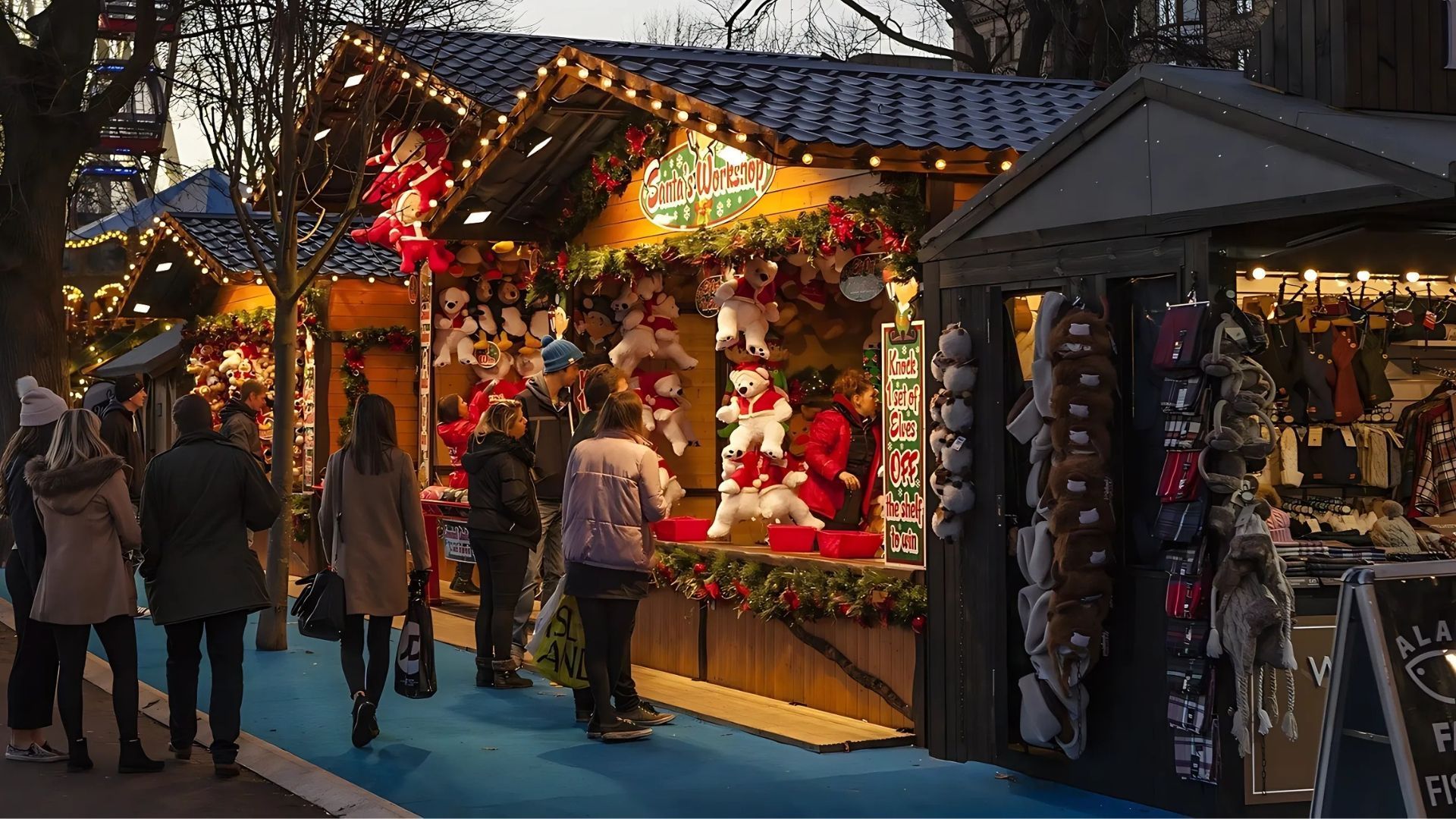 Christmas market stalls with lights, decorations, and people shopping outdoors.