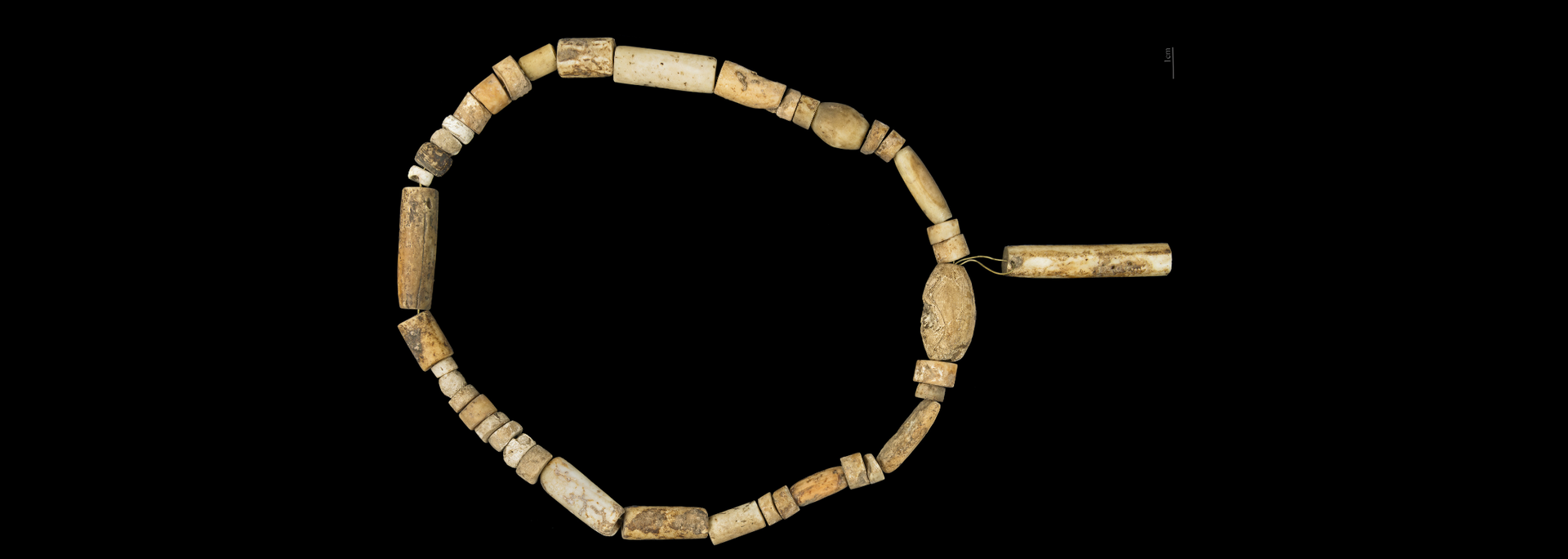 Beaded necklace against a black backdrop.