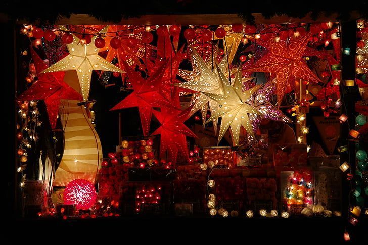 Christmas display with red and white illuminated star decorations and lights.