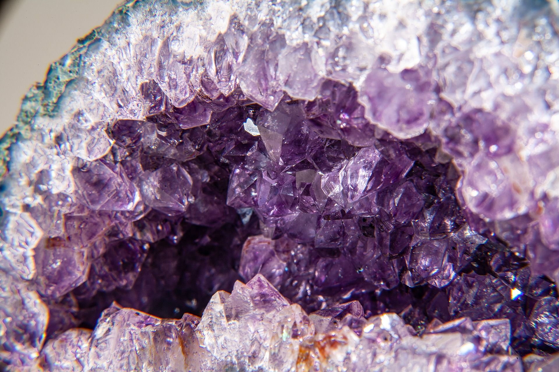 Amethyst geode, with clusters of deep purple crystals within a light blue encasing.