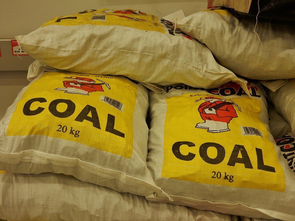 Bags of coal stacked, labeled 