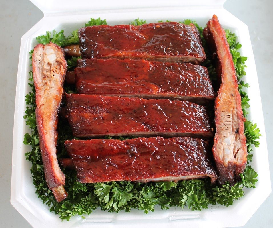 Platter of glazed ribs on parsley, with two rib bones on the sides