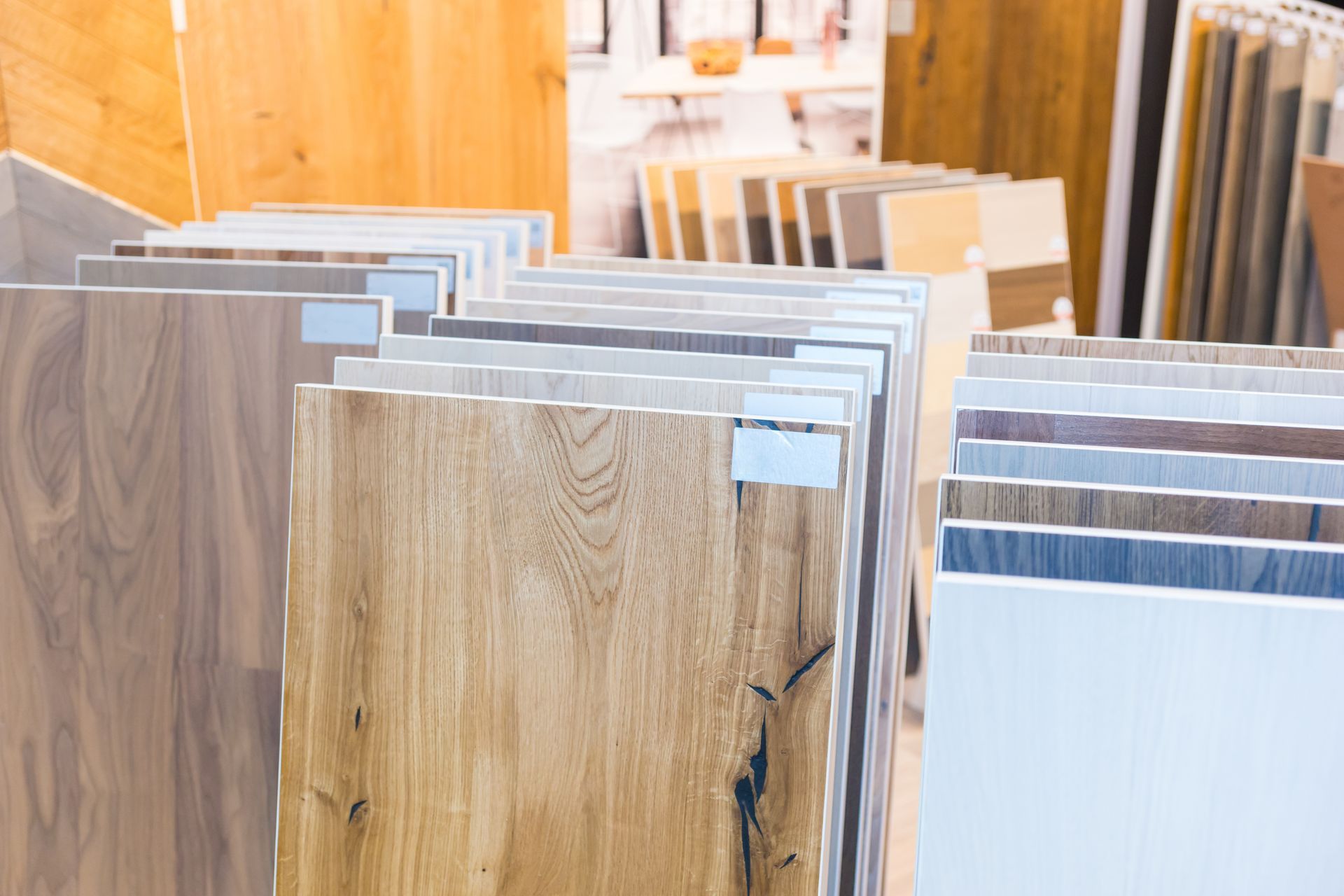 Rows of wood and laminate flooring samples displayed in a showroom