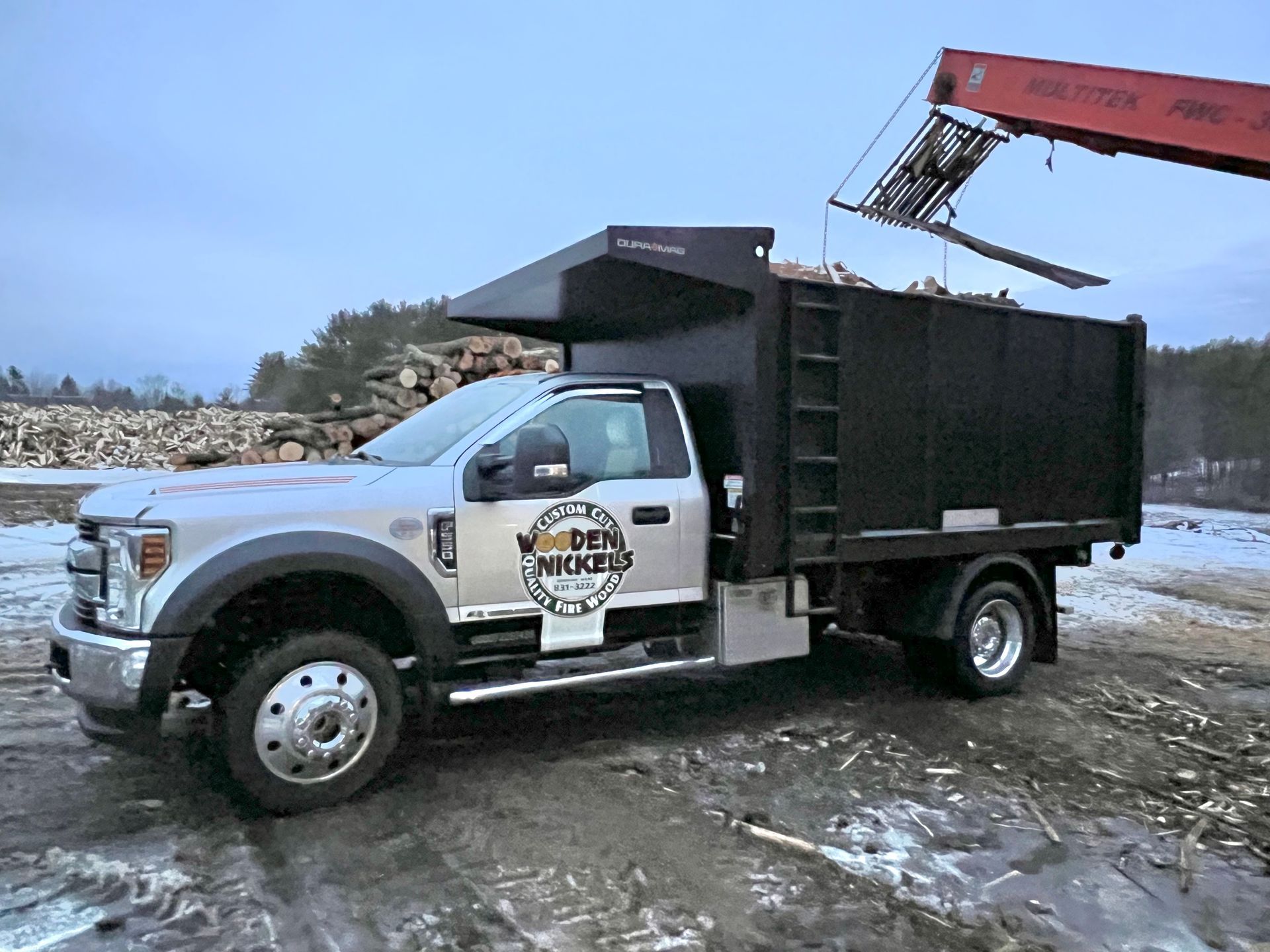 Firewood Delivery Truck Being Loaded By Crane