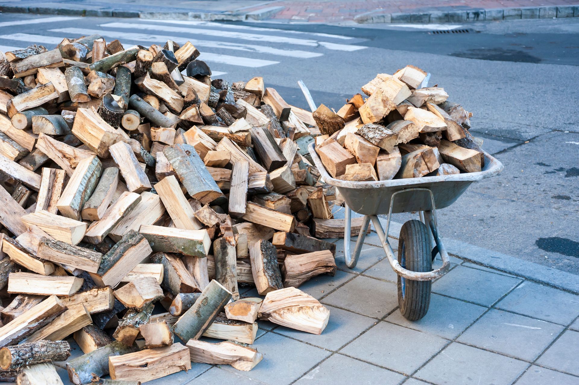 Pile of Firewood for Sale and Wheelbarrow