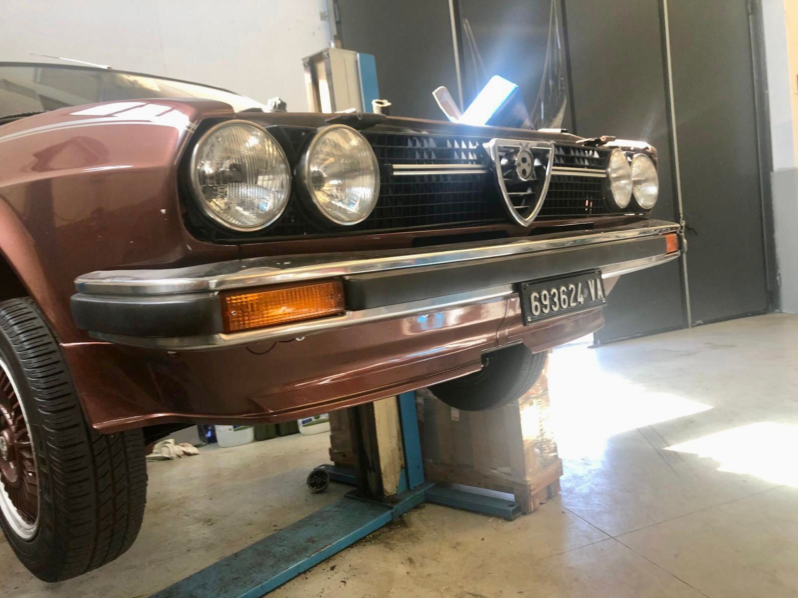 Un'auto rossa è parcheggiata su un ascensore in un garage.