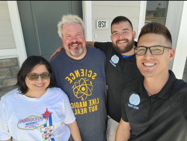 a group of people posing for a picture with one man wearing a shirt that says science