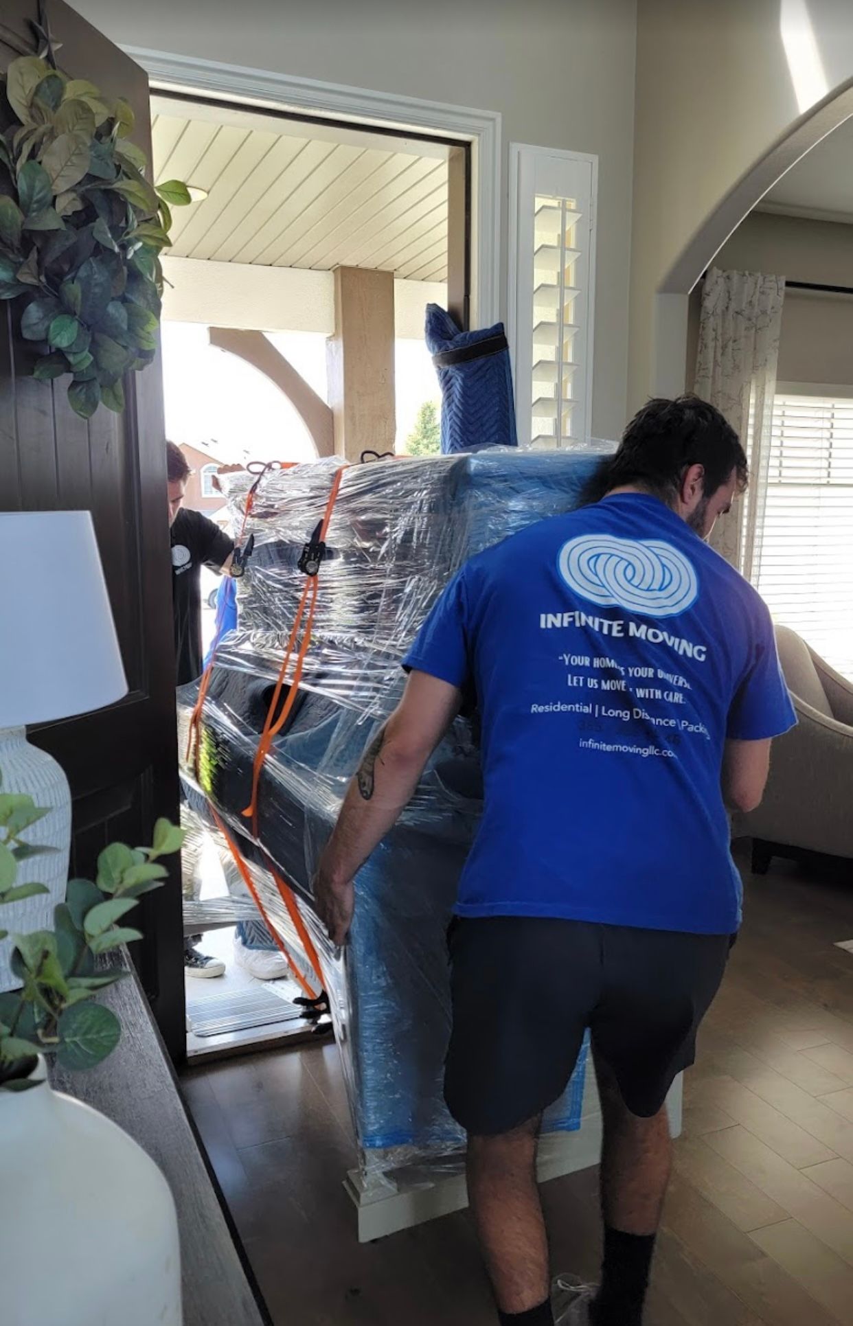 a man is carrying a table in a living room .