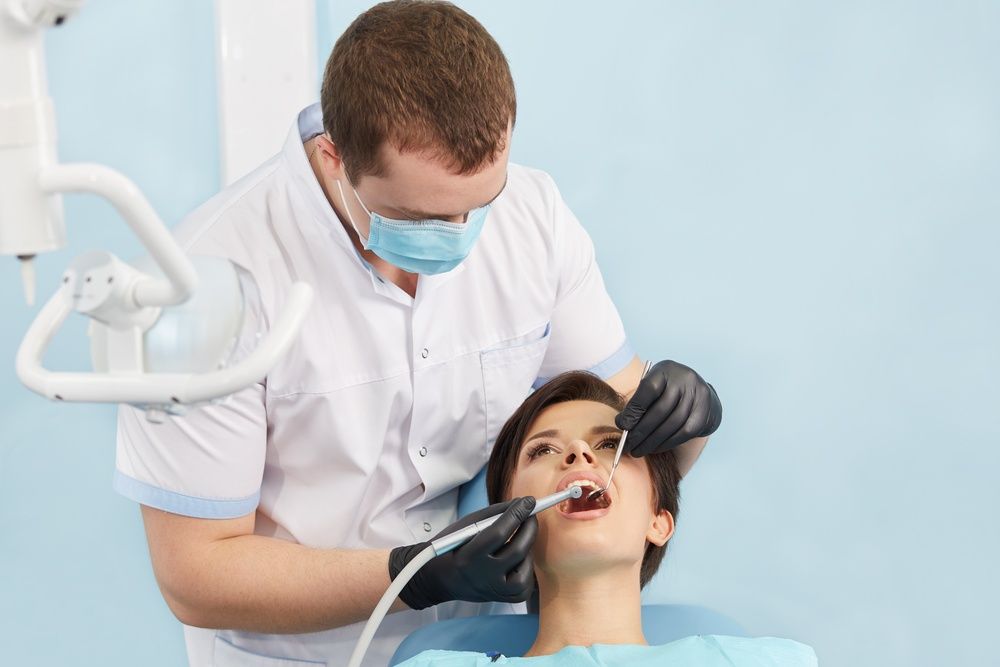 A dentist with a patient, offering dental care.