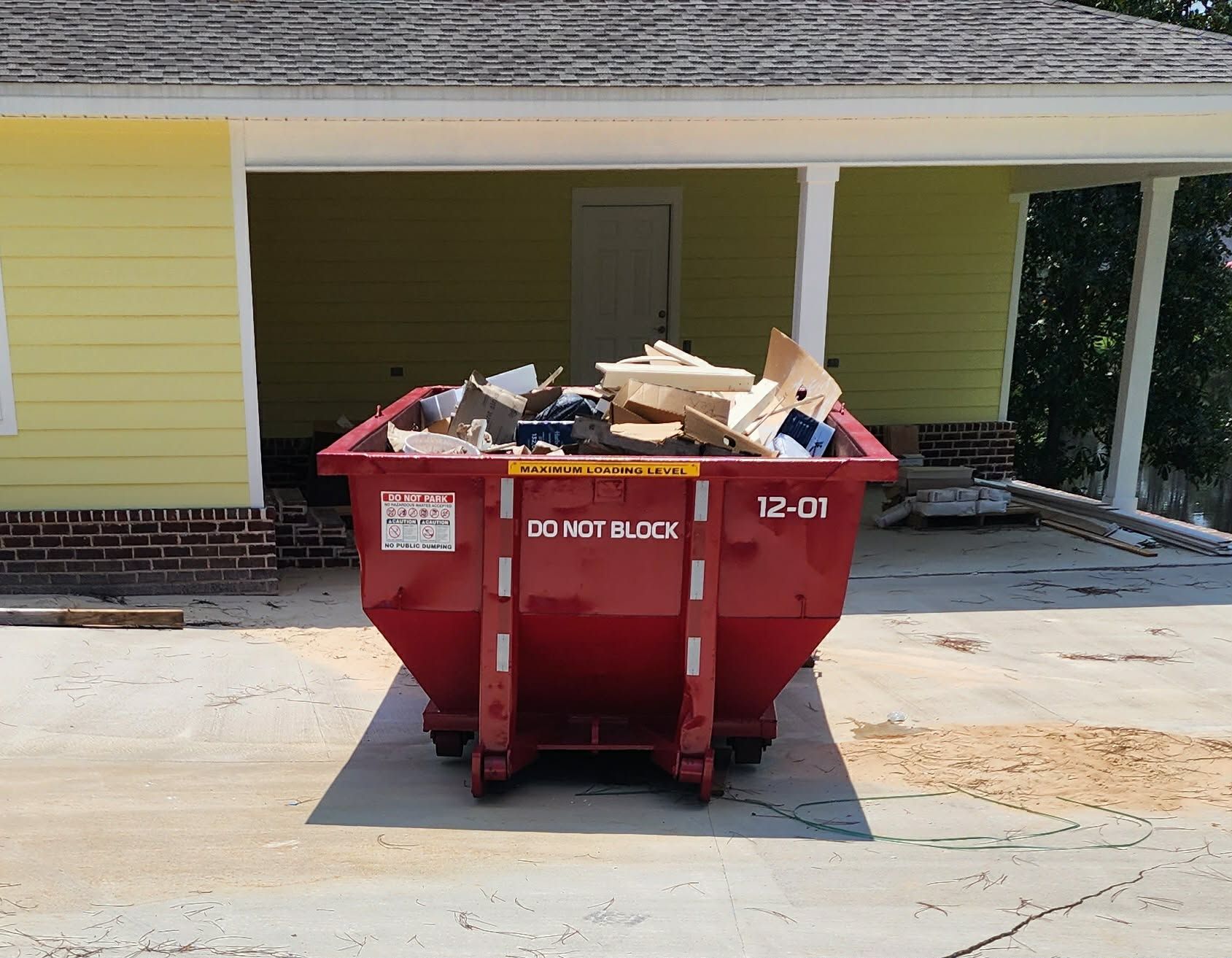 Loaded 12-yard Double O & Co roll off dumpster at a residential project