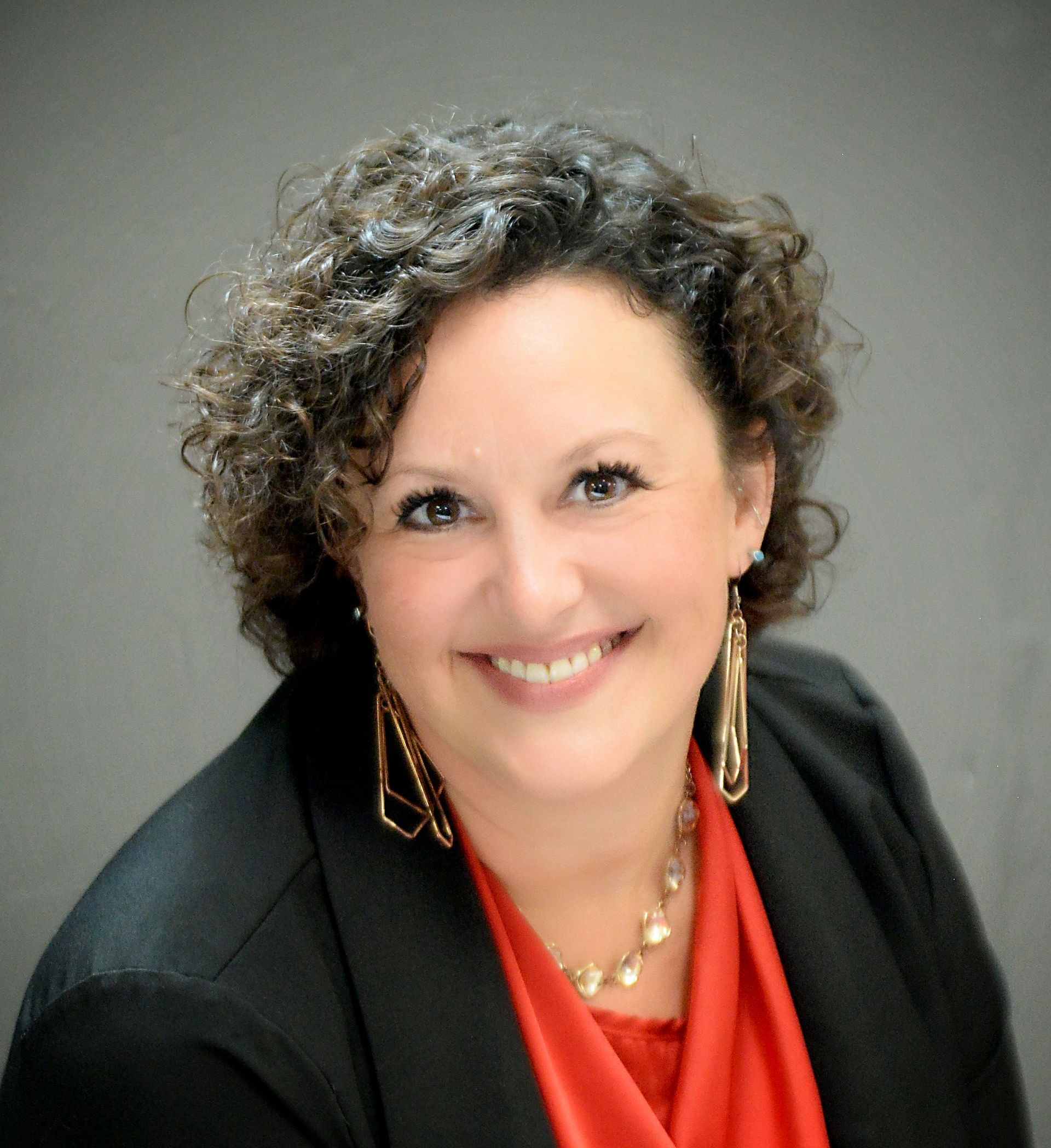 Hello! I'm Heather Wortley, a long standing member of the Lake Odessa community going on 25 years. I have over 15 years of Office Managing and customer service experience with over half of that in the recreational industry and recreational insurance side of the business. Our customers can trust that whether they walk in or call in, they will receive personal and professional service that they can trust and count on to answer their questions and care for their home, auto, business, life and recreational insurance needs. Smiling person with curly hair in a black blazer and orange top against a gray background