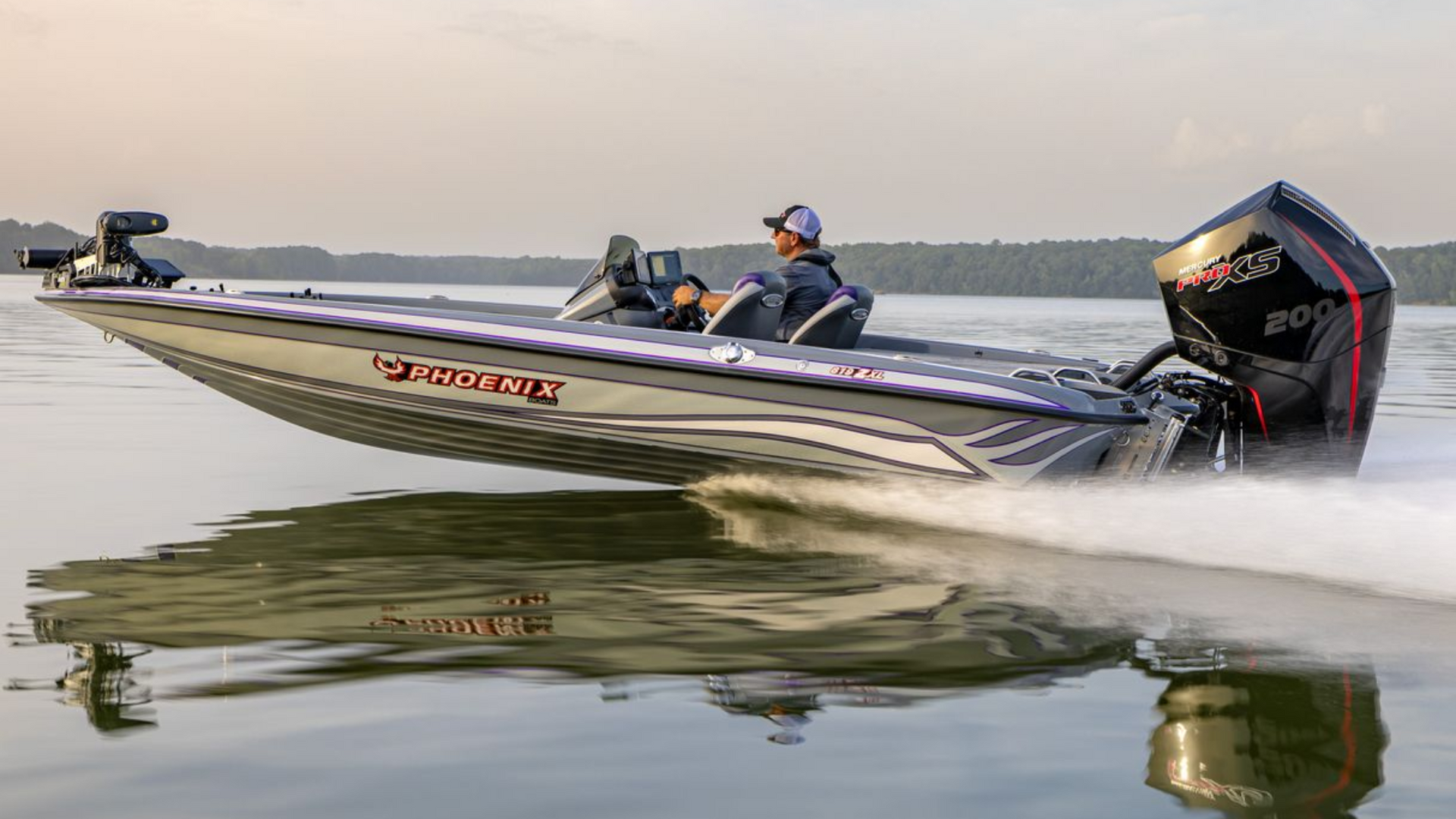 Bass Boat racing across calm water, one person aboard, spraying white wake at sunset