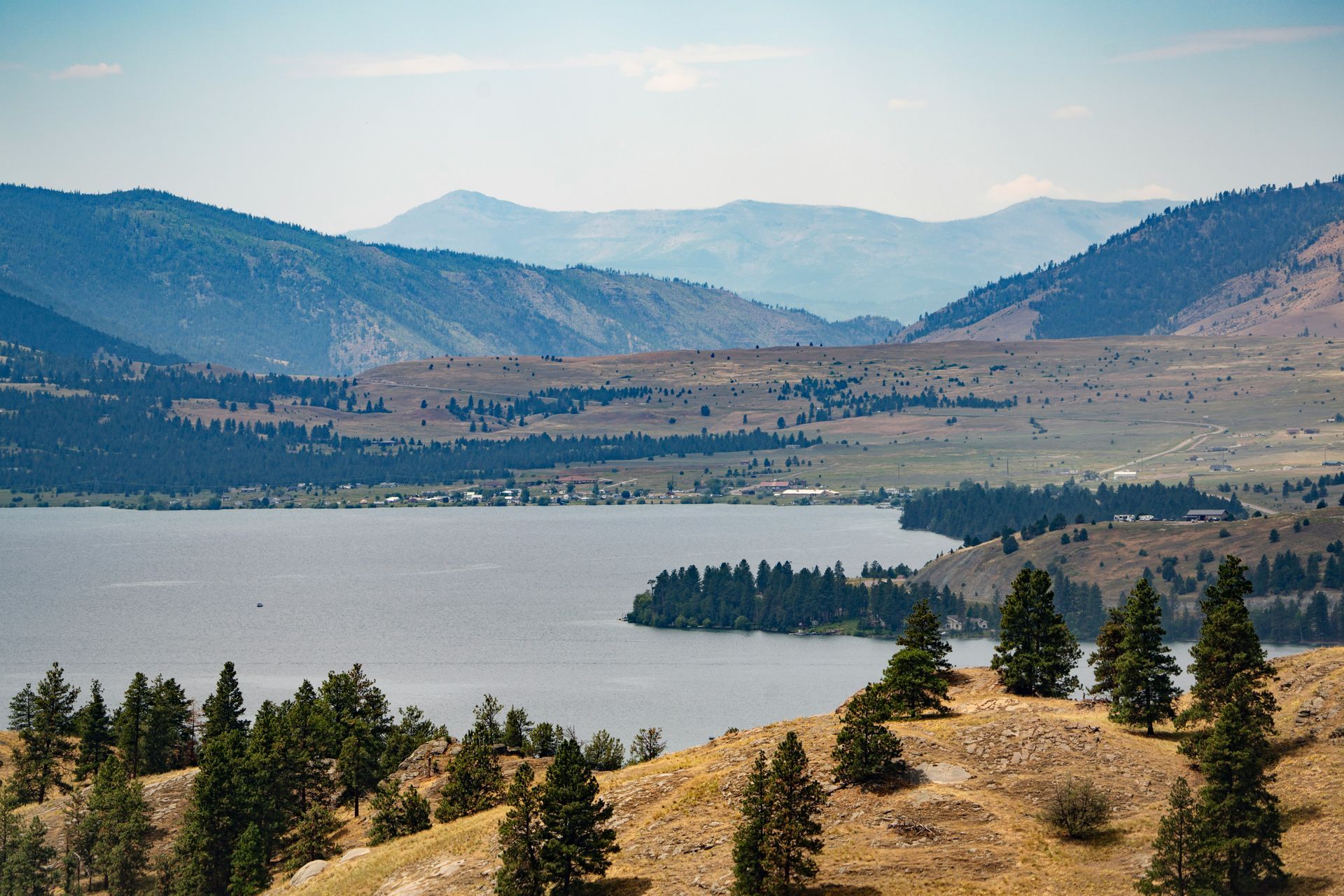 Flathead Lake surrounded by mountains under a blue summer sky, Montana