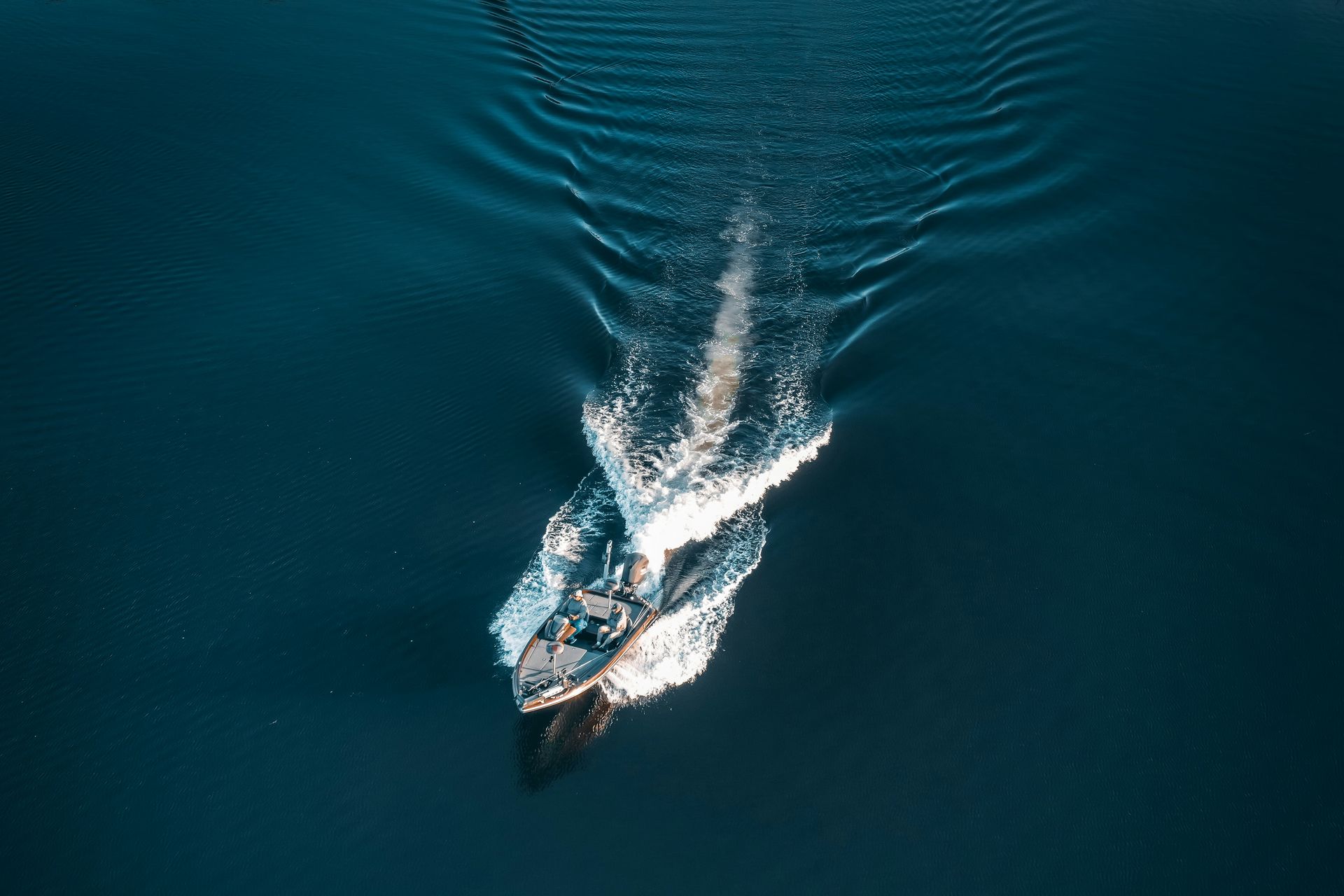 Small fishing boat on calm water at sunrise in Okoboji, Iowa