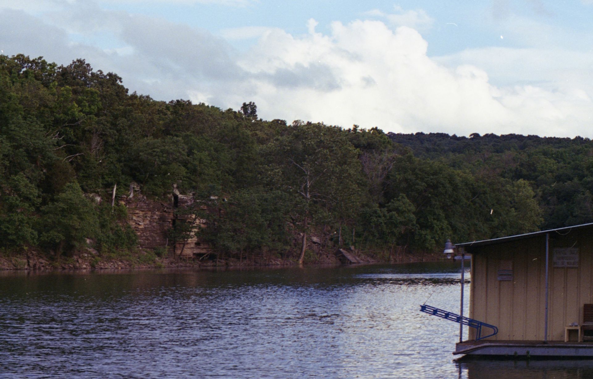 Boat on Tenkiller Lake near green trees in Oklahoma