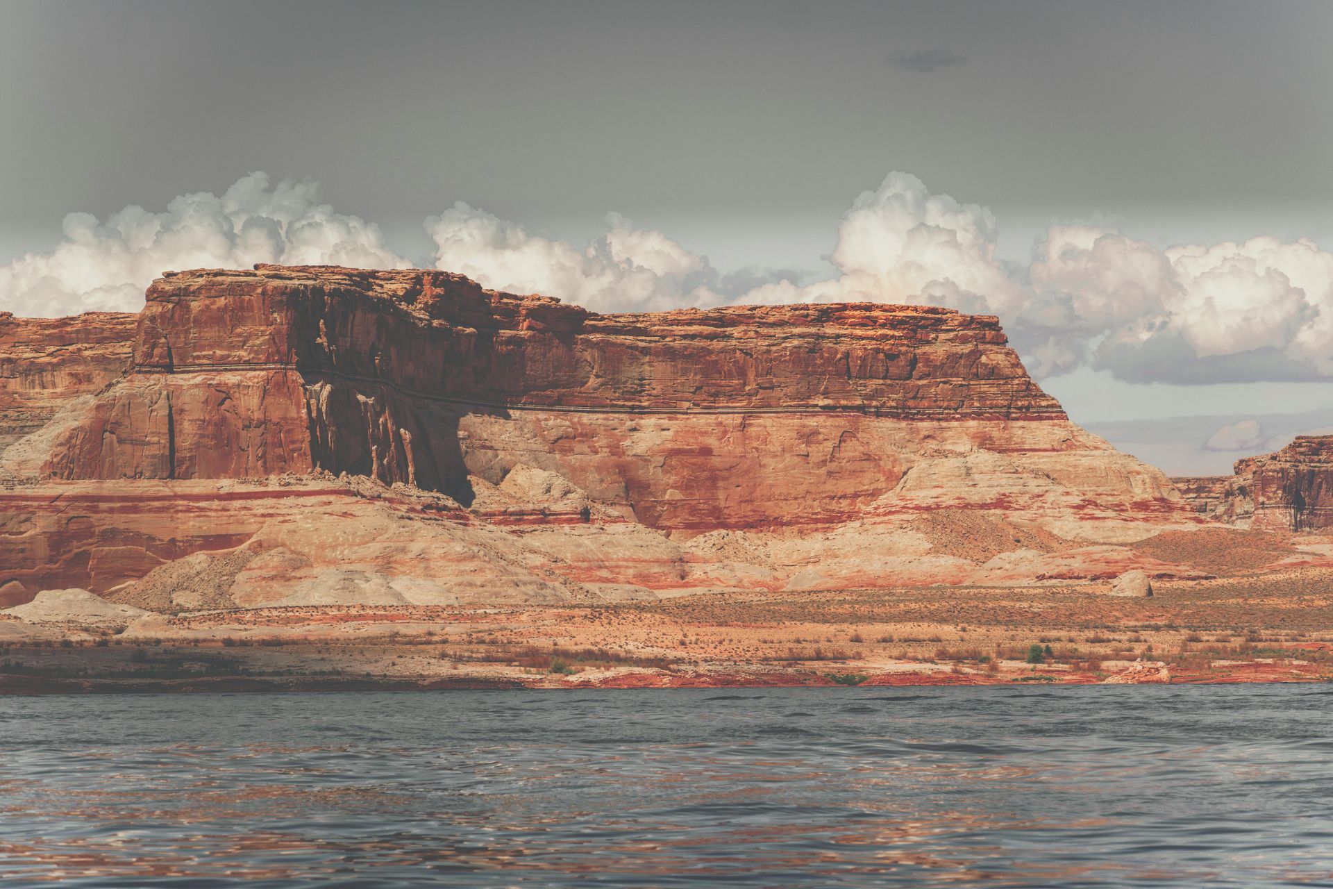 Red rock formation beside the water of Lake Powell, Utah