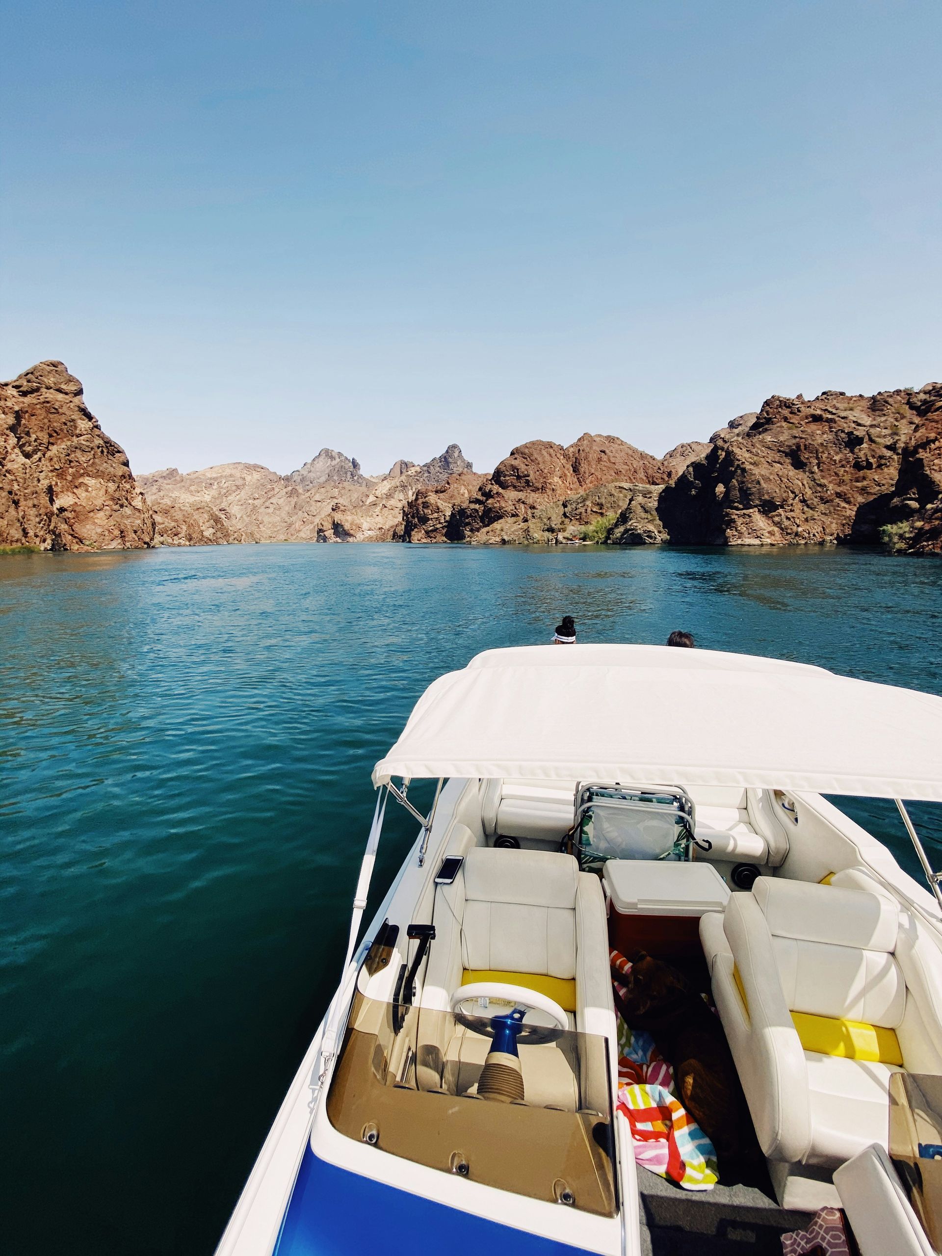 White and yellow boat on the blue water of Lake Havasu, Arizona