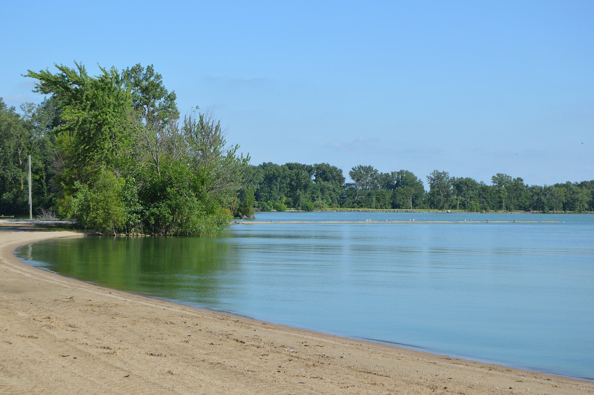 Sandy beach and calm blue water at Grand Lake St. Marys in Ohio