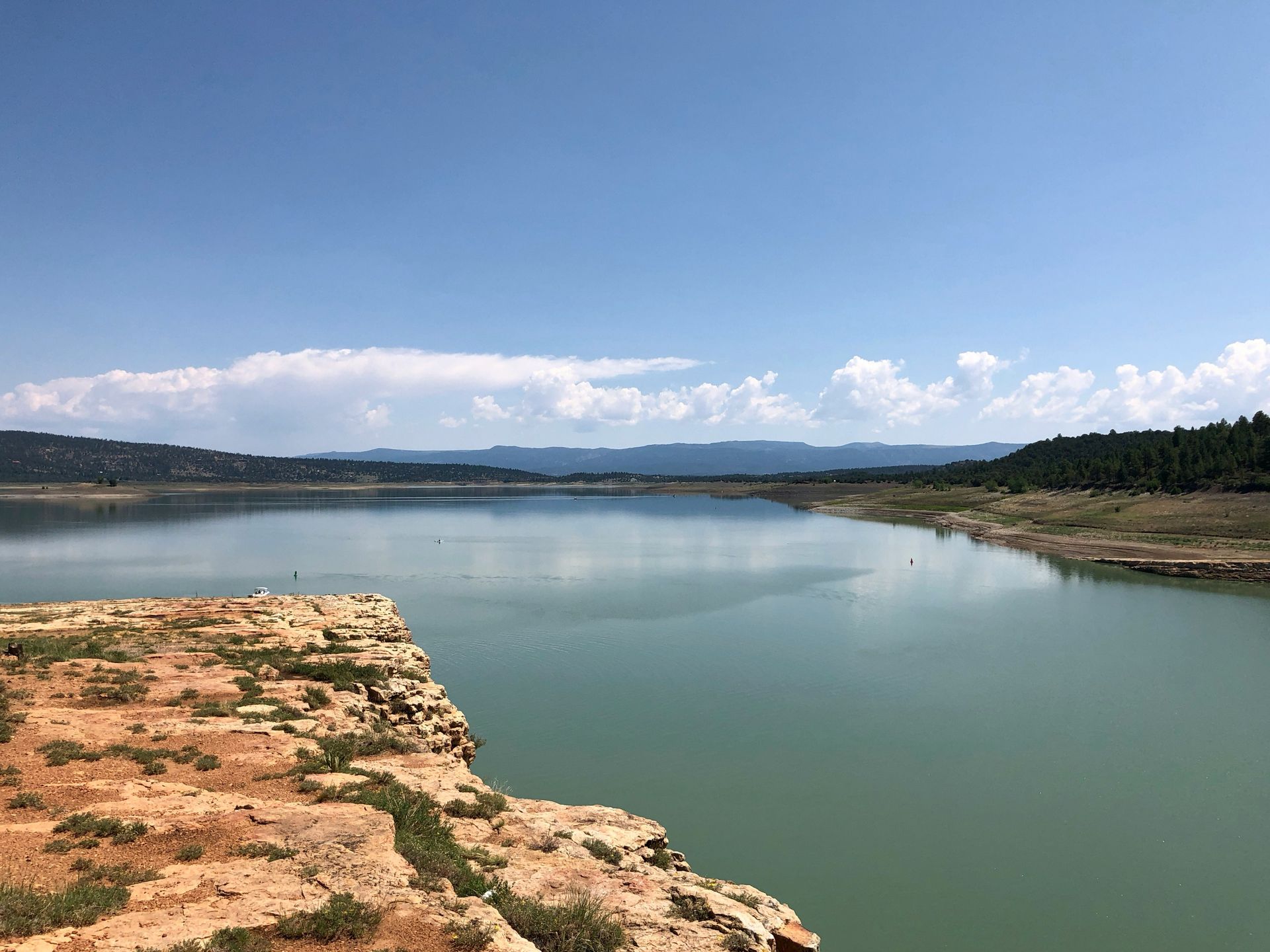 Rock formation beside the calm water of Heron Lake, New Mexico