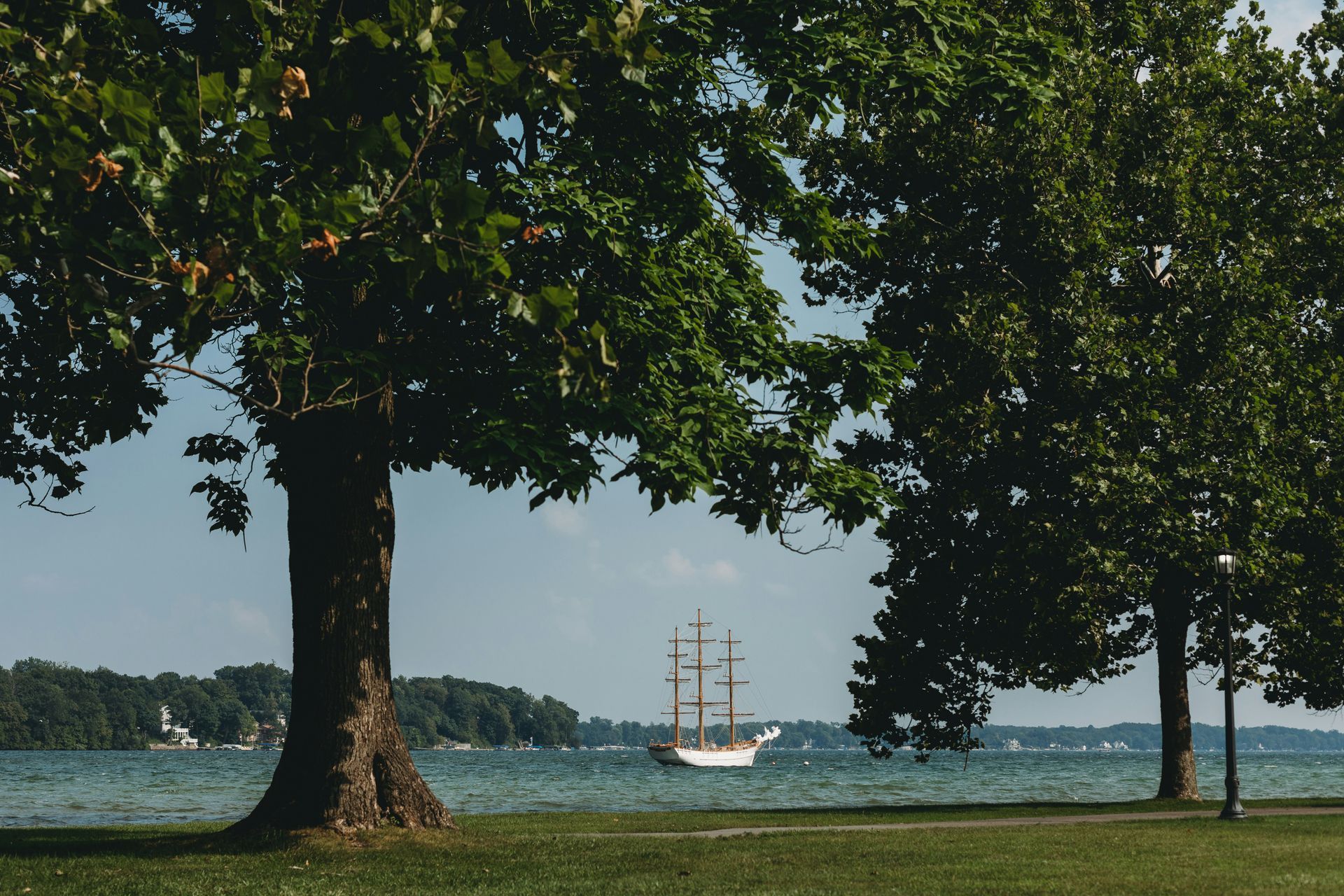 Boat on Lake Maxinkuckee near Culver, Indiana, with a tree along the shoreline